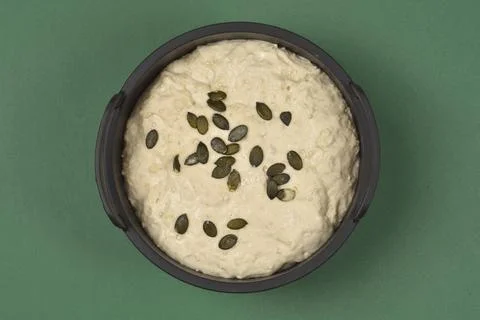 Raw Bread Dough with Pumpkin Seeds in Baking Pan Top View Stock Photos