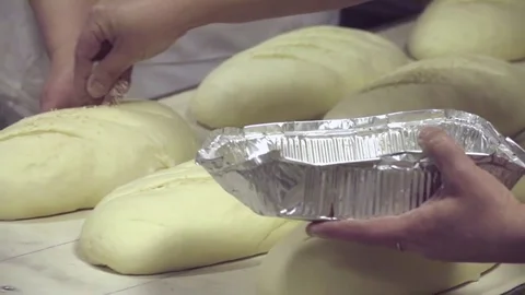 Raw bread loaves before baking at bakery HD slow-motion video. Production Stock Footage 74727591