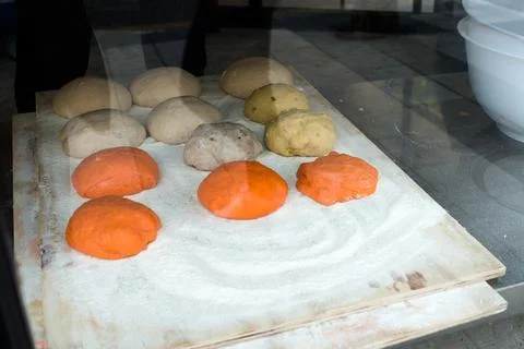 Raw bread pieces on a tray. Stock Photos