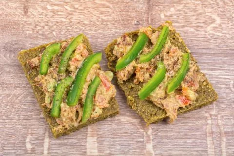 Raw bread with a spread decorated with pepper Stock Photos