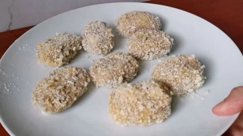 Raw Breaded Chicken Nuggets on a Plate Stock Footage 231360809
