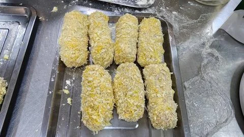 Raw Breaded Meat Rolls with Panko Breadcrumbs on a Stainless Steel Tray Pre.. Stock Photos