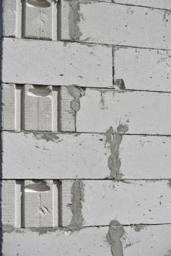 Raw brickwall with visible concrete lines Stock Photos