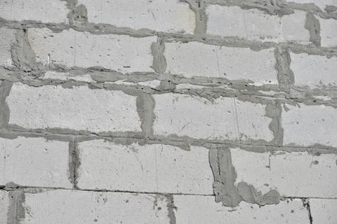 Raw brickwall with visible concrete lines Stock Photos