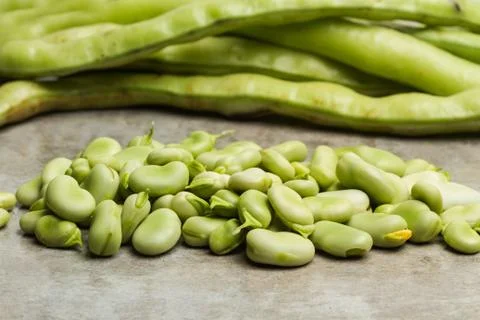 Raw broad beans on a marble table Foto stock