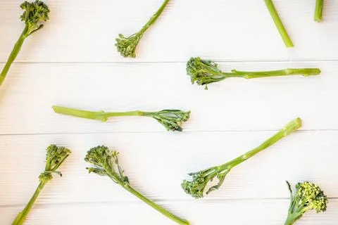 Raw broccolini on white table. Stock Photos