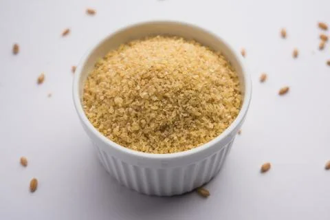 Raw Broken Wheat or Daliya or Dalia, selective focus Stock Photos