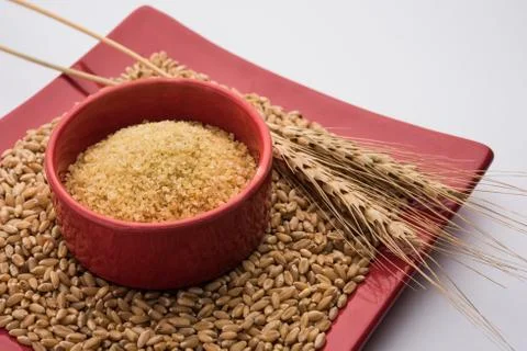 Raw Broken Wheat or Daliya or Dalia, selective focus Stock Photos