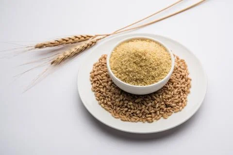 Raw Broken Wheat or Daliya or Dalia, selective focus Stock Photos