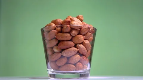 Raw brown nuts peanut rotates close-up macro Stock Footage 113846914