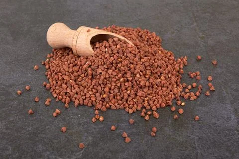 Raw buckwheat on black Stock Photos