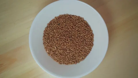 Raw buckwheat in a plate before before cooking Видео 168433074