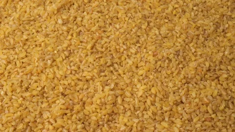 Raw bulgur wheat grains slowly moving close-up Stock Footage 344897327