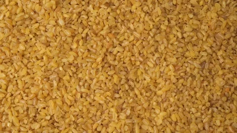 Raw bulgur wheat groats background texture Stock Footage 342437100