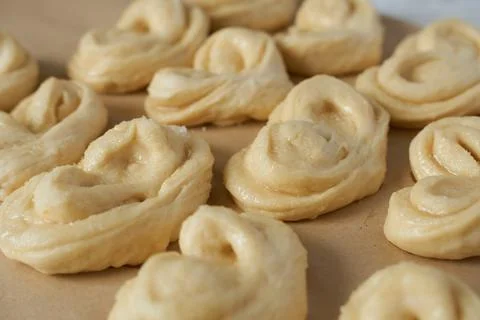 Raw buns on a baking sheet, close-up. Stock Photos