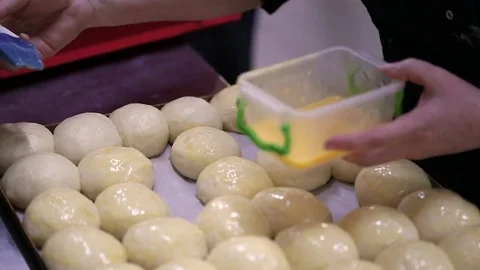 Raw buns on a baking sheet Stock Footage 72871439