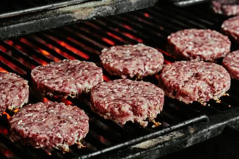 Raw burger cutlets - cutlets made from organic beef on a grill. raw cutlets Stock Photos