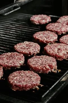Raw burger cutlets - cutlets made from organic beef on a grill. raw cutlets Stock Photos