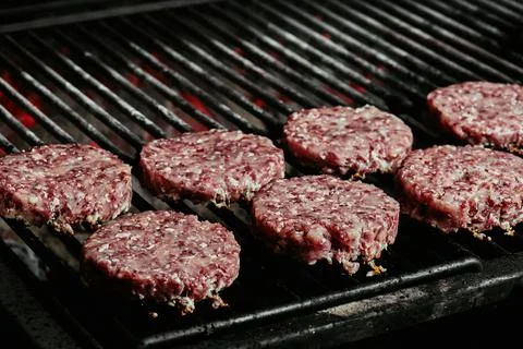 Raw burger cutlets - cutlets made from organic beef on a grill. raw cutlets Stock Photos
