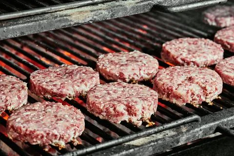 Raw burger cutlets - cutlets made from organic beef on a grill. raw cutlets Stock Photos
