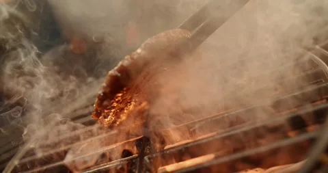 Raw burger meat falling on hot grill grate with flames and red spices for c.. Stock Footage 337389465
