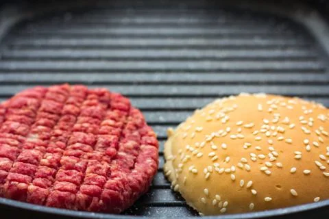 Raw burger in pan Stock Photos