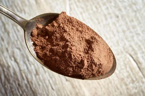 Raw cacao on a spoon Stock Photos