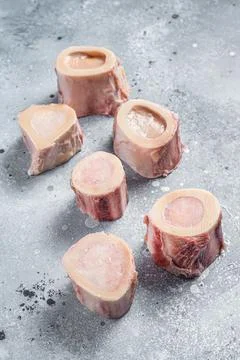 Raw calf Marrow bones on butcher table. Gray background. Top view Stock Photos