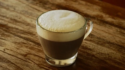 Raw cane sugar on cappuccino Stock Footage 95438432