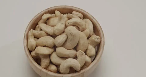 Raw cashew nuts rotating in slow motion close up Video stock 329293038