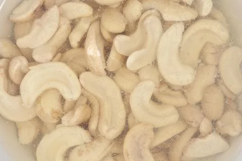 Raw cashew nuts soaking in water Stock Photos