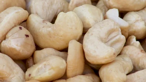 Raw Cashew Nuts Spread Across Surface Stock Footage 338160566