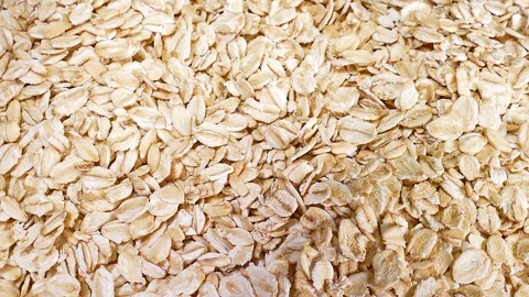 Raw cereal oat flakes on Rotating Rolling Plate Background Video For Any Use Stock Footage 127503006