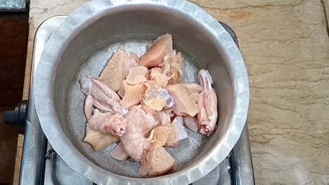 Raw Chicken Added to Cooking Pot on Stove, Preparing Chicken Potato Pie Filling, Stock Footage 323351883