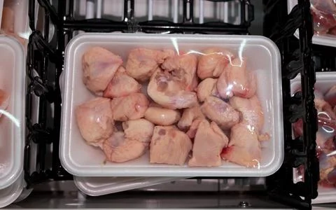 Raw chicken butt tail end parts packed in a container at a supermarket. aka  Stock Photos