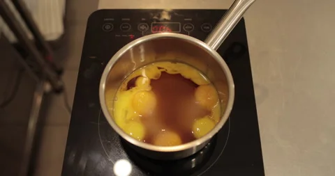 Raw chicken eggs are broken into a metal bowl on the table Stock Footage 256982051