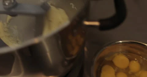 Raw chicken eggs are broken into a metal bowl on the table Stock Footage 256984526