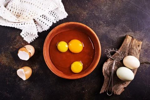 Raw chicken eggs on dark table Stock Photos