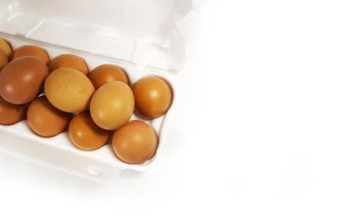 Raw chicken eggs in egg box on white background. Foto stock
