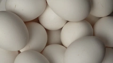 Raw chicken eggs rotating, top view Stock Footage 340812725