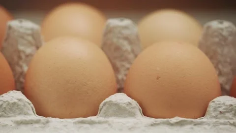 Raw chicken eggs in a tray on a brown background, slider shot 4K UHD 스톡 동영상 142881211