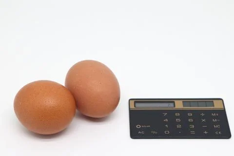 Raw chicken eggs on a white background. Weight loss, diet and weight control. Stock Photos