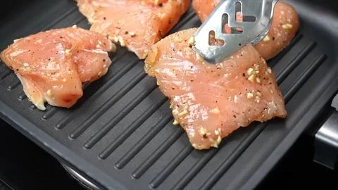 Raw Chicken frying in pan Stock Photos