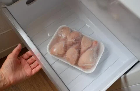 Raw chicken legs in the freezer Stock Photos