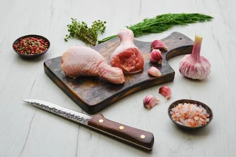 Raw chicken legs on wooden cutting board ready for cooking Stock Photos