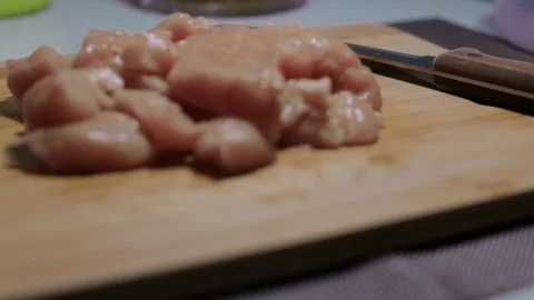 Raw chicken meat on a cutting board, cooking at home Stock Footage 128387616