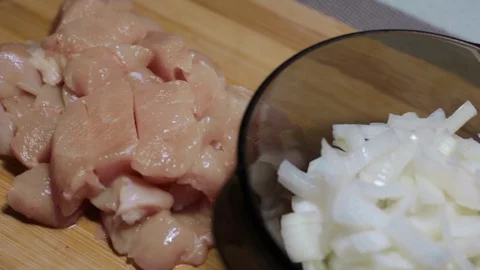 Raw chicken meat on a cutting board, cooking at home Stock Footage 128387672