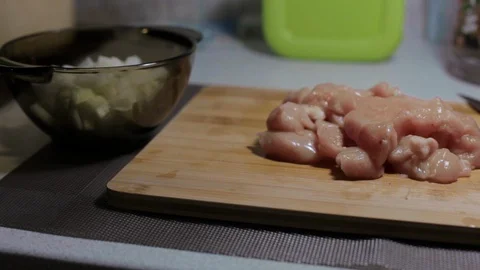 Raw chicken meat on a cutting board, cooking at home Stock Footage 128387694