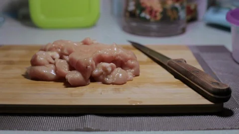 Raw chicken meat on a cutting board, cooking at home Stock Footage 128387737