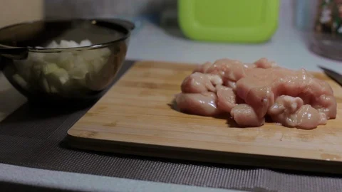 Raw chicken meat on a cutting board, cooking at home Stock Footage 128387760